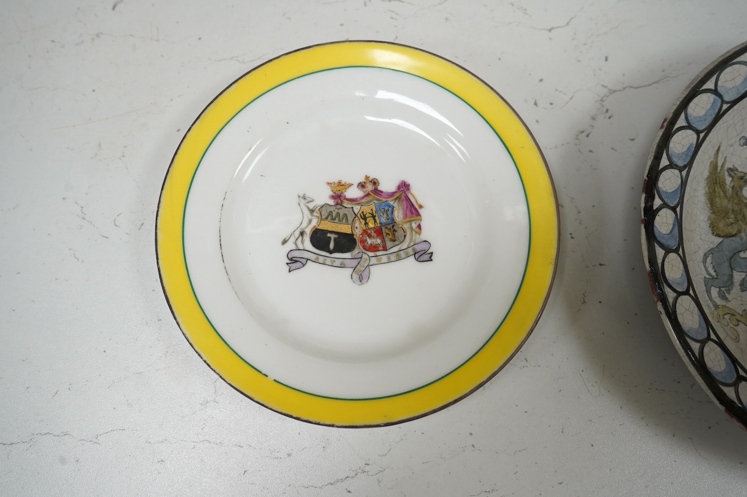 Two 19th century Russian Kornilov Brothers armorial plates and another pottery plate, largest 18cm in diameter. Condition - fair